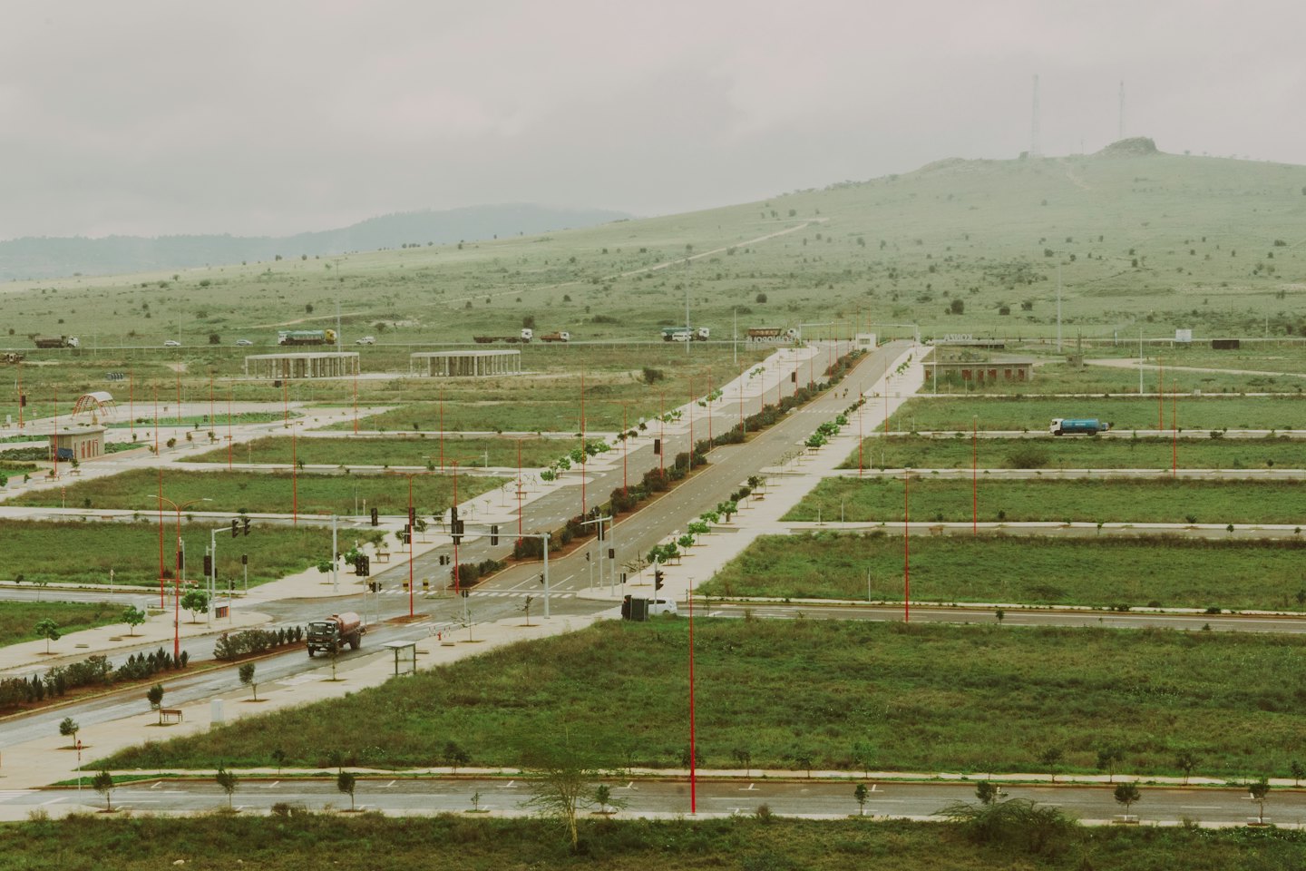 Construction vehicles parked on roads in a new housing development.