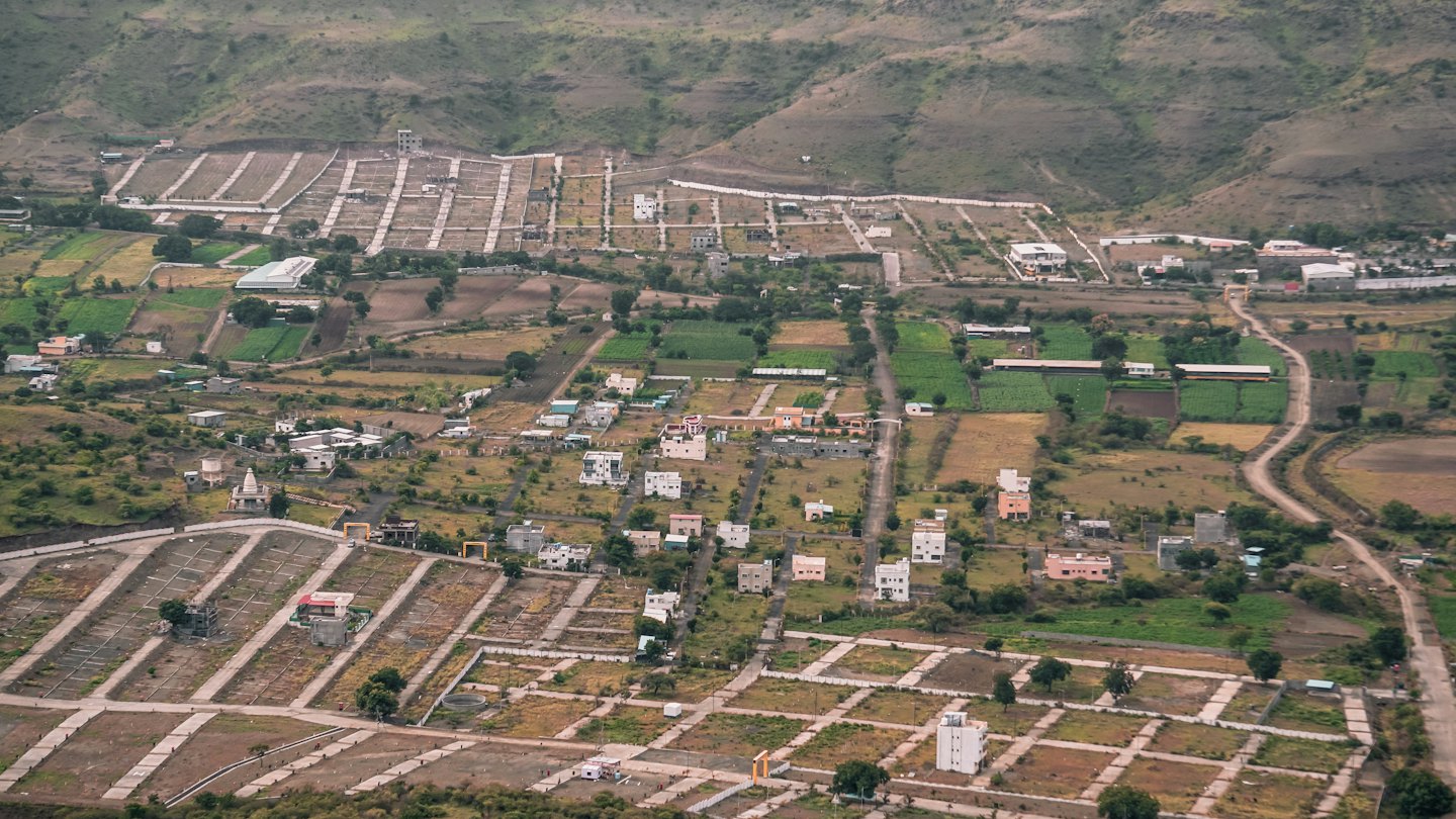 Rural landscape with small houses and new construction plots.